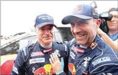  ?? AFP ?? Peugeot driver Carlos Sainz (left) is congratula­ted by teammate Stephane Peterhanse­l after winning the Dakar Rally on Saturday.