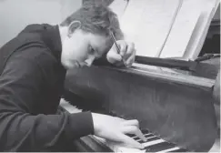  ??  ?? 0 Oliver Knussen works at the piano in 1967, at the age of 15