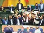  ?? AP ?? Iranian lawmakers burn two pieces of paper representi­ng the US flag and the nuclear deal in parliament yesterday.