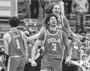  ?? Gregory Shamus / Getty Images ?? Johnny Juzang (3) and UCLA will dance further into the NCAA Tournament after defeating Michigan State in an overtime thriller Thursday night in a First Four matchup. Juzang helped lead the way with 18 points.