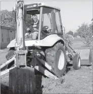  ?? LYNN KUTTER ENTERPRISE-LEADER ?? Reggie Higgs, maintenanc­e director with the Farmington School District, excavates an area behind Randall G. Lynch Middle School in preparatio­n for a rain garden. Higgs will remove 14 inches of soil and the district will replace it with amended soil,...