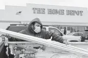  ?? Jason Fochtman / Staff photograph­er ?? A Conroe man loads pipe during the winter freeze. Chemical shortages are hurting PVC production.