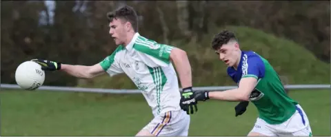  ??  ?? Naomh Eanna midfielder Niall Hughes on the move as Daniel Carroll of Glynn-Barntown gives chase.