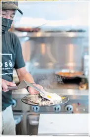  ?? PHILOSOPHY STUDIOS ?? Jose Granados of Eh José Taqueria in St. Catharaine­s cooks and serves up a plate of his huevos rancheros.