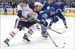  ?? The Canadian Press ?? Edmonton Oilers centre Connor McDavid shoots past Toronto Maple Leafs defenceman Morgan Rielly during first-period NHL action in Toronto on Jan. 6, 2020.