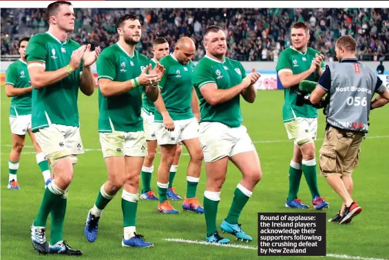  ??  ?? Round of applause: the Ireland players acknowledg­e their supporters following the crushing defeat by New Zealand