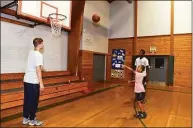  ?? Ned Gerard / Hearst Connecticu­t Media ?? UConn’s Joey Calcaterra, left, and Nahiem Alleyne work with summer campers Monday at the Wakeman Boys & Girls Club in Fairfield.