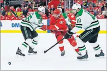  ?? [DUANE BURLESON/THE ASSOCIATED PRESS] ?? Detroit’s Frans Nielsen, center, is blocked off the puck by Dallas’ Brett Ritchie, left, and Martin Hanzal during Tuesday’s game. RANGERS 5, FLYERS 1: