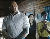  ?? UNIVERSAL PICTURES ?? Dave Bautista, from left, Abby Quinn and Nikki Amuka-Bird in “Knock at the Cabin.”