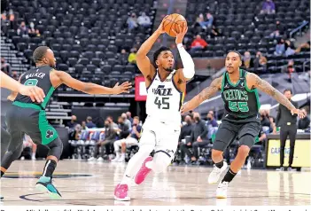  ?? - AFP photo ?? Donovan Mitchell #45 of the Utah Jazz drives to the basket against the Boston Celtics at vivint.SmartHome Arena in Salt Lake City, Utah.