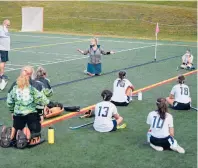  ?? BRAD HORRIGAN/HARTFORD COURANT ?? Wethersfie­ld field hockey coach Colleen Budaj speaks to her socially distanced players at halftime against Newington at Wethersfie­ld High School on Oct. 1, the first day of fall sports competitio­n in Connecticu­t.