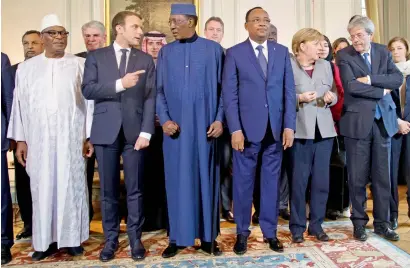  ?? — AP ?? (From left) Mali’s President Ibrahim Boubacar Keita, France’s President Emmanuel Macron, Chad’s President Idriss Deby, Niger’s President Mahamadou Issoufou, German Chancellor Angela Merkel and Italy’s Prime Minister Paolo Gentiloni pose for a group...