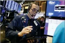  ?? RICHARD DREW — THE ASSOCIATED PRESS ?? Trader Gregory Rowe works Wednesday on the floor of the New York Stock Exchange.