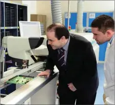  ?? File photo ?? Dairymaste­r CEO Dr Edmond Harty and Billy Burke examine circuit boards used in the company’s Cool Control system .