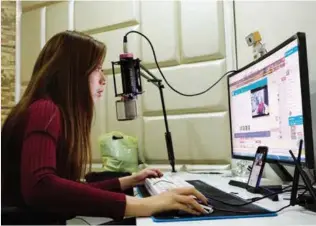  ??  ?? Meiko uses a profession­al studio to broadcast her live shows. Companies such as hers are springing up all over China to provide working spaces for aspiring Kuaishou celebritie­s