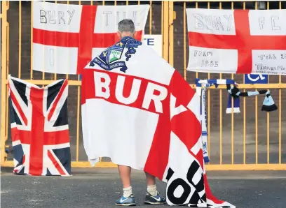  ?? Peter Byrne ?? A Bury supporter at the closed Gigg Lane gates