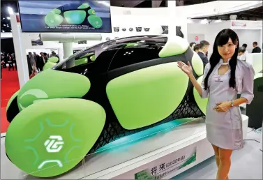  ?? REUTERS ?? A model presents the Flesby, a one-seater mobility concept car exhibited by Japan’s auto parts maker Toyoda Gosei, during a media preview of the 45th Tokyo Motor Show in Tokyo, Japan, on Wednesday.