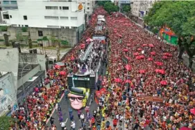  ?? AP PHOTO/ANDRE PENNER ?? Above: A sound truck makes its way through a street crowded with revelers Feb, 7 during the “Academicos do Baixo Augusta” pre-Carnival street party in Sao Paulo, Brazil.