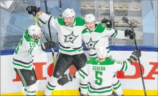  ?? Jason Franson The Associated Press ?? Dallas’ Blake Comeau (15), Jamie Oleksiak (2), Joel Kiviranta (25) and Andrej Sekera (5) celebrate the winning goal against the Avalanche on Friday. The Stars will play Vegas on Sunday.