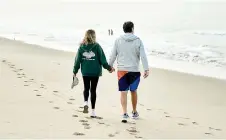  ?? ?? Daniel Eagle and his wife, Cindy, walk on the beach in Santa Monica, California. — The Washington Post photos
