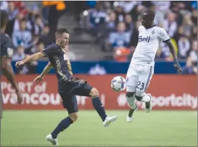  ?? The Canadian Press ?? Vancouver Whitecaps’ Kekuta Manneh, right, Philadelph­ia Union’s Keegan Rosenberry vie for the ball during first-half MLS action in Vancouver on Sunday.