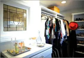  ??  ?? A vintage window was used to pass natural light from the large walk-in closet into the bathroom on the other side of this wall. (Jeff Wheeler/TNS)