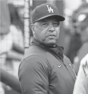  ?? BRAD MILLS/USA TODAY SPORTS ?? Dave Roberts in the dugout before the Dodgers game in Washington on Tuesday.