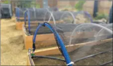  ?? COURTESY PHOTO ?? Taos Land Trust was able to build 80 ‘grow boxes’ to distribute to the community with the help of a grant from the Taos Community Foundation. Outfitted with shade cloth and a drip irrigation system, the garden boxes were planted with seedlings for squash, beans, broccoli and tomatoes.