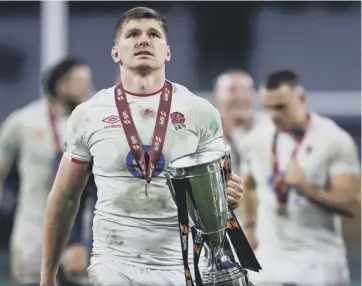  ??  ?? 0 England captain Owen Farrell holds the trophy after his side’s dramatic Cup final win over France