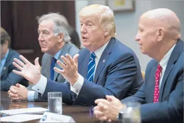  ?? SHAWN THEW/EPA ?? President Donald Trump meets Tuesday with House Ways and Means Committee Chairman Kevin Brady, right, ranking Democrat Richard Neal and other panel members.