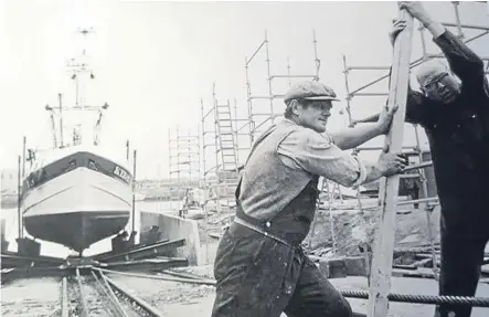  ??  ?? The first vessel on the slipway – Jimmy Gowans and Henry Anderson guide the Fidelitas KY 245.