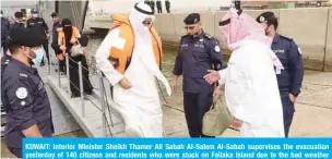  ?? — KUNA ?? KUWAIT: Interior Minister Sheikh Thamer Ali Sabah Al-Salem Al-Sabah supervises the evacuation yesterday of 140 citizens and residents who were stuck on Failaka Island due to the bad weather conditions this weekend.