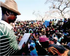  ??  ?? File photo shows people waiting to receive aid at a camp for the people displaced in the aftermath of Cyclone Idai in John Segredo near Beira, Mozambique. — Reuters photo