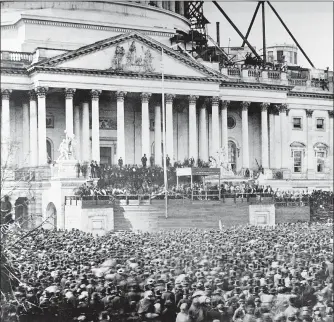  ?? ASSOCIATED PRESS FILE PHOTO ?? In this March 4, 1861 image, President Abraham Lincoln stands under cover at center of Capitol steps during his inaugurati­on in Washington. The scaffoldin­g at upper right was used in the constructi­on of the Capitol dome.