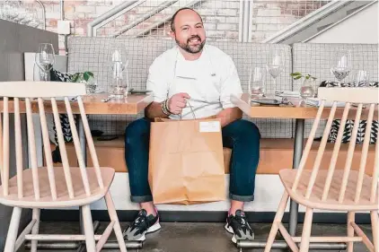  ?? Jacquelyn Martin/Associated Press ?? Matt Baker, chef and owner of Gravitas, inside the restaurant, on Feb. 14 in Washington. Gravitas has a subscripti­on service offering a monthly meal for two.