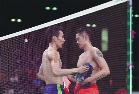  ?? AFP ?? China’s Lin Dan (right) and Malaysia's Lee Chong Wei exchange shirts after the latter’s victory in the men’s singles semifinal at the 2016 Olympic Games in Rio de Janeiro.