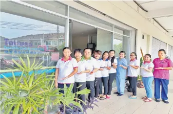  ??  ?? Teo (right) and her team of nursing staff pose at the entrance of the centre.