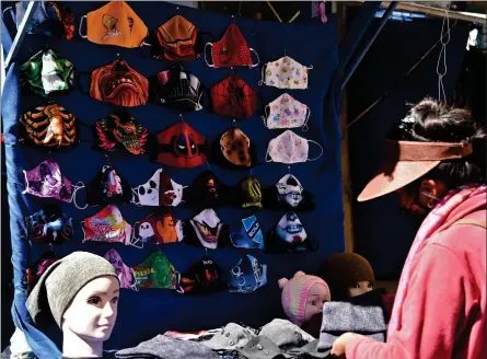  ?? Photo: Nampa/AFP ?? Focal point… A woman sells face masks at an open market in La Paz.