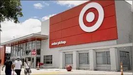  ?? Joe Raedle / Getty Images ?? Target announced that it expects profits will take a short-term hit, as it marks down unwanted items, cancels orders and ditches inventory.