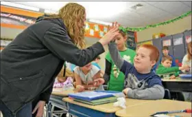  ?? SUBMITTED PHOTO ?? Jake Wainstein gives his teacher Mrs. Isola a high-five after completing a science experiment.