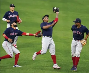  ?? Ap ?? EYES ON THE BALL: Red Sox third baseman Rafael Devers makes a catch on a fly ball by the Orioles on Saturday.