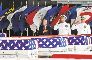  ?? Ronen Zilberman / AFP / Getty Images ?? Vice President Mike Pence (left) welcomes the remains after they were taken to Hawaii.