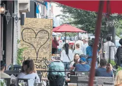  ?? STEVE RUSSELL/TORONTO STAR ?? Street life returned to Danforth on Tuesday, as stores and restaurant­s reopened on the Greektown strip.