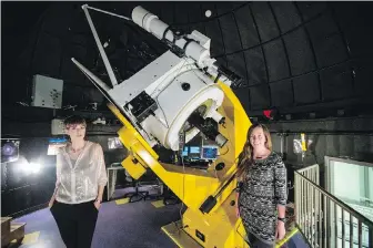  ??  ?? Ondrea Clarkson, left, and Clare Higgs at the University of Victoria observator­y in the Bob Wright Centre. Higgs got to see the cosmic event of a lifetime and recorded the observatio­ns. Clarkson, her colleague, deals more in the theoretica­l but was...