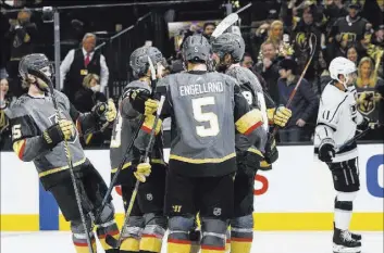  ?? Chase Stevens Las Vegas Review-Journal @csstevensp­hoto ?? Golden Knights players celebrate an empty net goal by Alex Tuch in the third period of a 2-0 victory against the Los Angeles Kings on Tuesday at T-Mobile Arena.