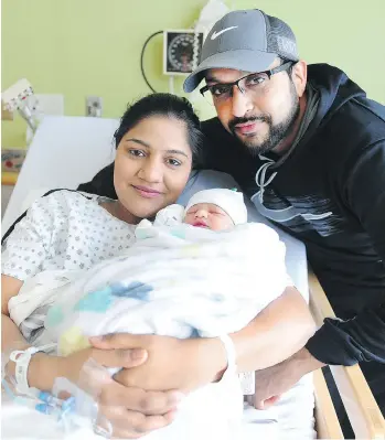  ??  ?? First-time mom Manpreet Kaur Nijjar and dad Hardip Singh Shergill pose proudly with their daughter — no name yet — at Surrey Memorial Hospital. She was delivered nine seconds past midnight on New Year’s Day.
