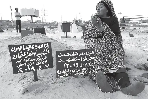  ?? Claire DOYEN / AFP ?? KHADOM, the mother of Al-Moez visits the tomb of her son, killed when a bullet pierced the window of his workplace and lodged itself in his heart during an anti-government demonstrat­ion in the Sudanese capital Khartoum in April, on July 9, 2019. Like dozens of others who lost a son, uncle or brother, Al-Moez’ family has paid a high price for Sudan’s revolution that toppled its longtime autocratic ruler Omar al-Bashir in April.