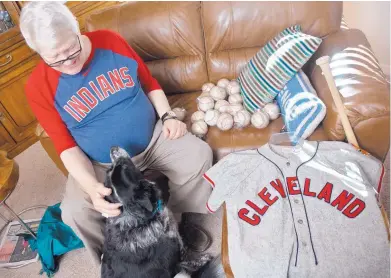  ?? MARLA BROSE/JOURNAL ?? Allen Broyles, with his dog, Bella, in his Rio Rancho home, still has the jersey he wore when he was a batboy for the Cleveland Indians in 1948.