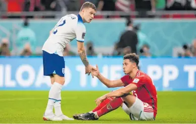  ?? Photos / AP ?? England’s Kieran Trippier shakes hands with a despondent Ethan Ampadu after England’s 3-0 win.