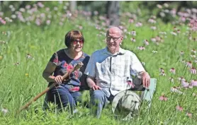  ?? ANGELA PETERSON, MILWAUKEE JOURNAL SENTINEL ?? Jean and Tom Weedman relax in one of their prairies in the Town of Eagle on June 23. Their home will be part of the Wild Ones Kettle Moraine Chapter’s Native Garden Tour.